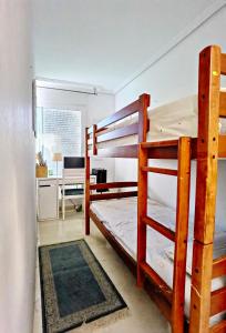 a bedroom with two bunk beds and a desk at Oasis Beach in Altea