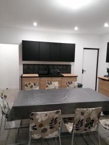 a dining room with a large table and chairs at Chez Stephanie in Rang-du-Fliers