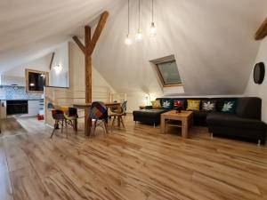 a living room with a couch and a table at Apartmán Konírna in Harrachov