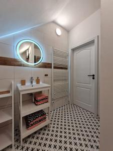a bathroom with a sink and a mirror at Apartmán Konírna in Harrachov