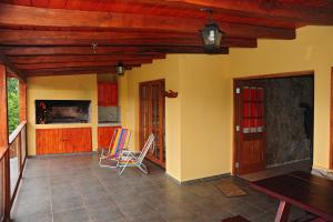 a living room with two chairs and a table at Terrazas al Champaqui in Villa Yacanto +60 photos
