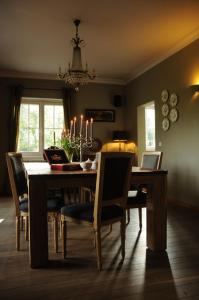 a dining room with a table and chairs and a chandelier at B & B De Bleker in Bruges