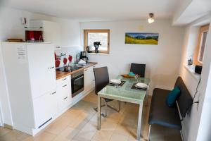 a small kitchen with a table and a small dining room at Bergblick in Hopferau