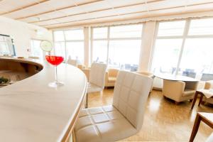 a wine glass sitting on a counter in a room at Werzers Seehotel Wallerwirt in Techelsberg am Worthersee