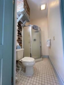 a bathroom with a toilet and a glass shower at Carriage House Bed & Breakfast in Winona