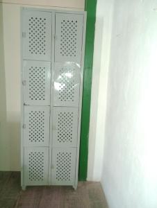 a white door in a room with a green wall at Hostel L B in São Luís
