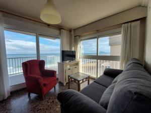 a living room with a couch and a large window at Apartamento Bellavista in Daimuz