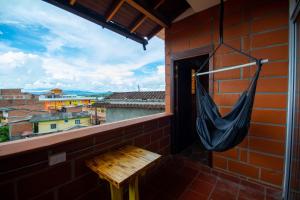 a hammock on a balcony with a view at Hotel Le Chateau Guatape in Guatapé