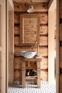 a bathroom with a sink in a wooden wall at Willa Halna in Zakopane