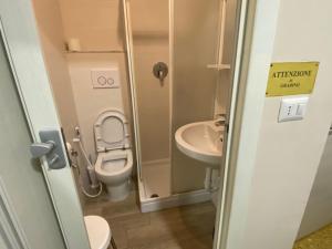 a small bathroom with a toilet and a sink at Hotel La Pergola in Loano