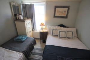 a bedroom with two beds and a window at Blue Skies in Deal