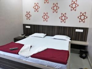 a bed in a room with avertisement for at Hotel Shiv Regency in Kukma