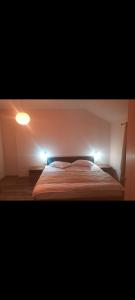 a bedroom with a bed with two lights on it at Ski View in Poiana Brasov