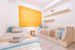a bedroom with two beds with towels on them at Nice 3 Bedroom Villa in El Duque in Adeje +12 photos