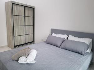 a bedroom with a bed with towels on it at 5 mins to MidValley Netflix 3Bedroom in Johor Bahru +19 photos