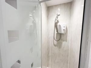 a shower with a glass door in a bathroom at 1Bd Glasgow Apartment in Glasgow