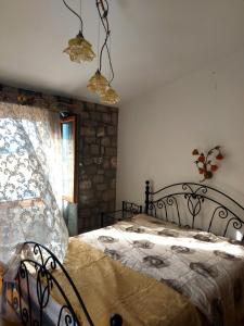 a bedroom with a bed and a window at Xenios Petritis in Levádeia