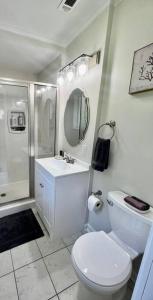 a bathroom with a toilet and a sink and a shower at Spacious House Minutes to Beach, Casino, Aquarium in Long Beach