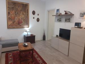 a living room with a couch and a tv at Casa Calù in Genoa