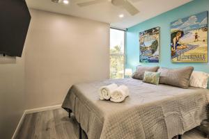 a bedroom with a large bed with towels on it at Fort Lauderdale Condo with Patio, Near Canal! in Fort Lauderdale