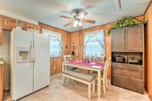a kitchen with a table and a white refrigerator at Jacksonville Getaway about 4 Mi to Downtown! in Jacksonville