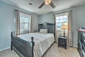 a bedroom with a bed and a ceiling fan at Jacksonville Getaway about 4 Mi to Downtown! in Jacksonville