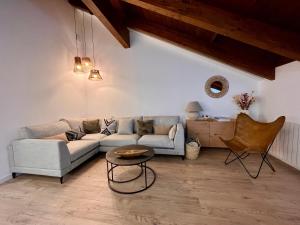 a living room with a couch and a table at BPIRINEOS-Ibón Blanco in Benasque