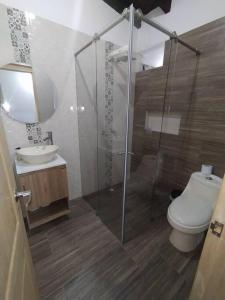a bathroom with a shower and a toilet and a sink at Hermosa casa ideal para el descanso in Rionegro +14 photos