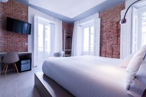 a bedroom with a large bed and a large window at B&B Hotel Madrid Centro Fuencarral 52 in Madrid