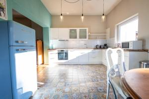 a kitchen with white cabinets and a table and chairs at Haus Ludwig Murmeltier in Garmisch-Partenkirchen