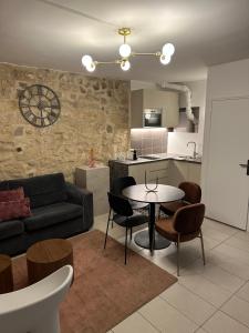 a kitchen and a living room with a table and chairs at Temple Apartments Paris in Paris