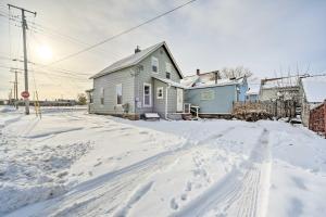 una casa en una calle cubierta de nieve con una señal de stop en Lake Superior Getaway Near Marina and Beaches!, en Ashland