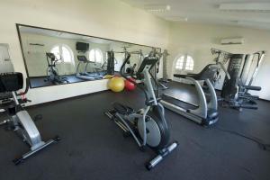 a gym with several exercise bikes and a mirror at Sapphire Beach Condos in Christ Church
