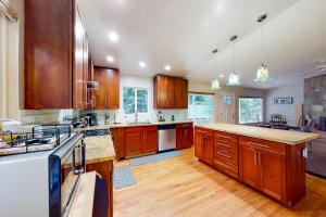 a large kitchen with wooden cabinets and wooden floors at River Paradise in Guerneville