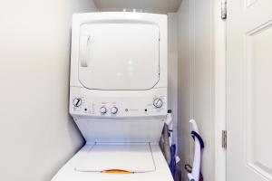 a white washer and dryer in a white kitchen at River Paradise in Guerneville