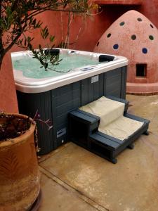 a jacuzzi bathtub in a room with at Riad Dar Ten in Marrakesh