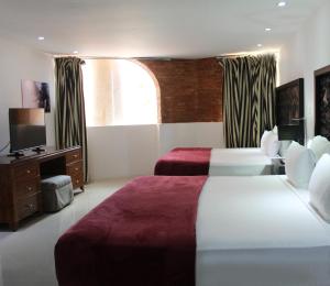 Tempat tidur dalam kamar di Essenzia de Cancun