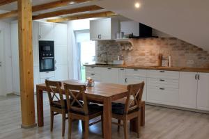a kitchen with a wooden table and chairs at Ferienwohnung Stefanko in Bernau