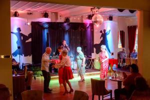a group of people dancing on a stage at Somerset Hotel in Llandudno