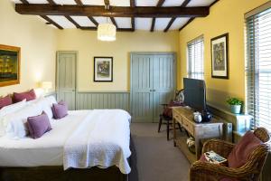 a bedroom with a large bed and a television at The Mistley Thorn in Mistley