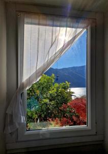 a window with a view of the water at Casa Melina 2 in Tremezzo