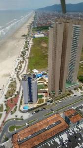 een luchtzicht op een stad met een strand en gebouwen bij Lindo Apto Pé na areia Frente para Mar in Praia Grande