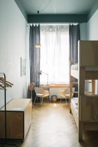 a bedroom with a bunk bed and a desk at casaBASE in Milan
