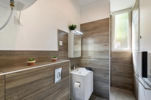 a bathroom with a toilet and a sink at La Maisonnette Du Parc in Le Creusot
