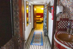 a bathroom with a tub and a tiled floor at Riad Baba in Fez +37 photos