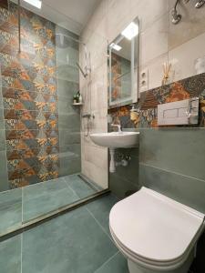 a bathroom with a toilet and a sink and a shower at Von Cruss apartments in Lviv in Lviv