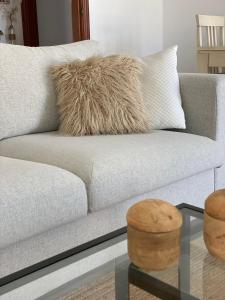 a white couch with a pillow and a glass table at Appartement Casa Lina Lagos vue mer in Lagos