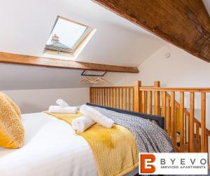 a bedroom with a bed with towels on it at ByEvo Oswestry Barn - Quirky romantic retreat or cosy contractor base in Oswestry