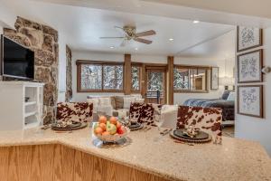uma cozinha e sala de estar com uma mesa com uma taça de fruta em Laurelwood Condominiums 304 em Snowmass Village