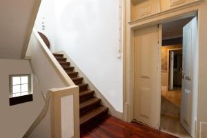 a staircase in a home with white walls and wooden floors at Rossio FLH Suites in Lisbon